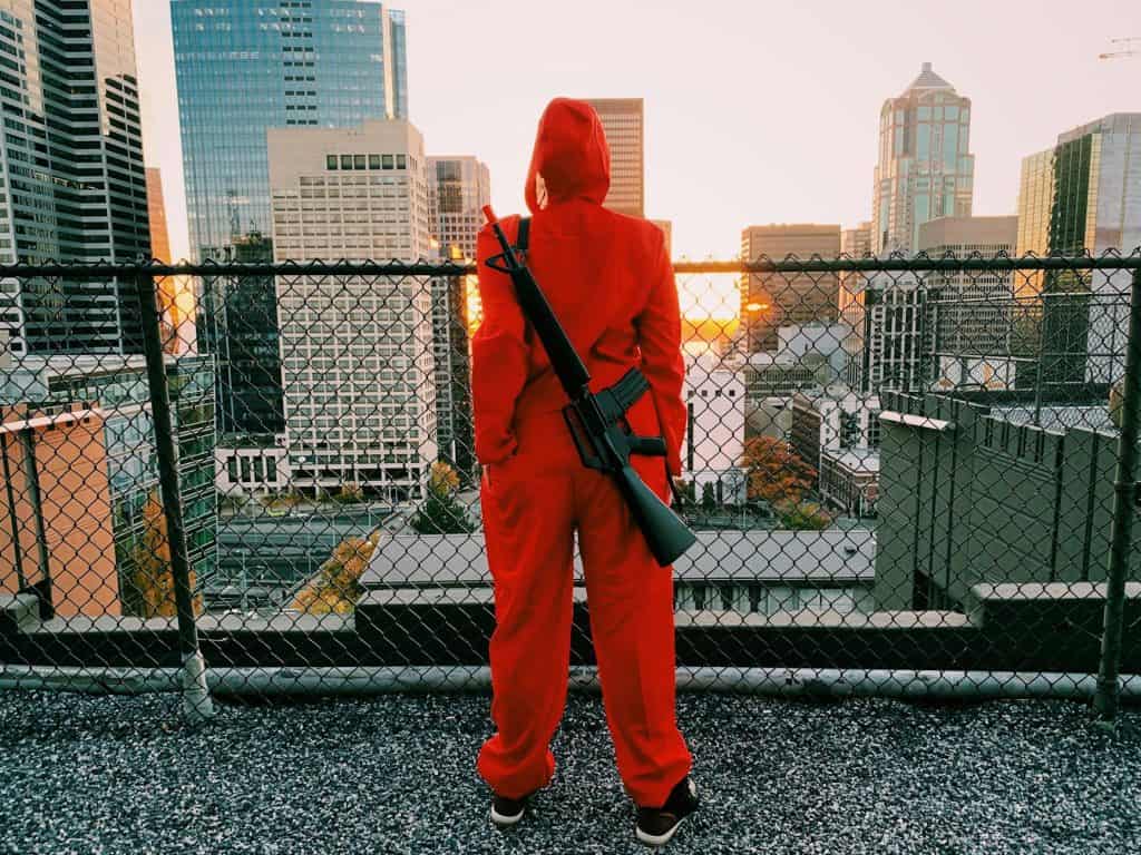 A watchful man carrying a gun, possibly looking out for wrong-doing