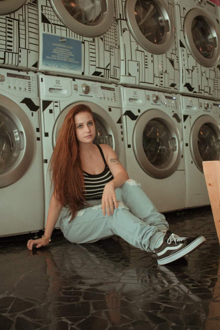 A woman surrounded by washing machines